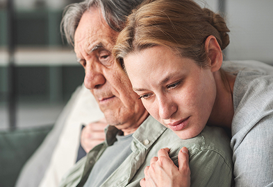 image of a middle aged woman hugging her father